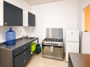 a kitchen with a stove and a refrigerator at Appartement 2 chambres in Moroni