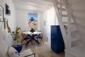 a room with a blue staircase and a table at Allium Art House Symi in Symi