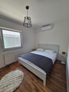 a bedroom with a bed and a window and a rug at Little Aria in Ripač