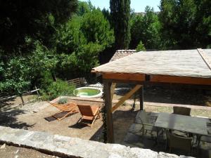 a patio with a table and chairs and a pool at Residenza termale Monte Santo in San Casciano dei Bagni