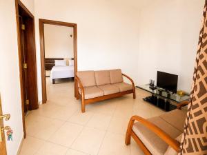 ein Wohnzimmer mit Sofa und Fernseher in der Unterkunft Appartement in Moroni