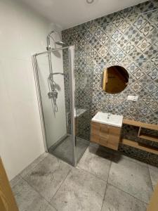 a bathroom with a shower and a sink at Domki hopSolina in Zawóz +68 photos