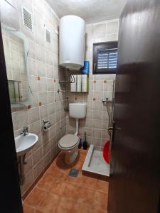 a bathroom with a toilet and a sink at Luminaria Solis kuća za odmor in Rogoznica