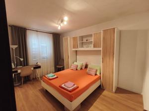 a bedroom with a bed and a desk in a room at Luminaria Solis kuća za odmor in Rogoznica