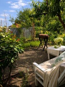 a garden with a table and a bench and a grill at Лана бугаз in Karolino-Buhaz