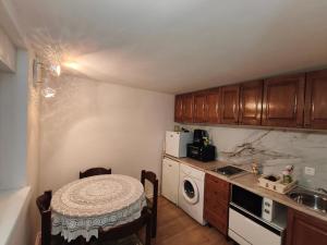 a small kitchen with a table and a microwave at Luminaria Solis kuća za odmor in Rogoznica +16 photos