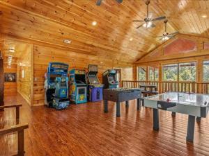 a large room with arcade games and ping pong tables at Greenbrier Estate in Pittman Center