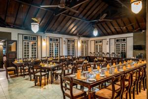 a large dining room with tables and chairs at Nature Trails Boutique Hotel in Unawatuna