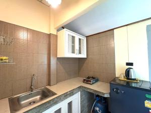 a kitchen with a sink and a counter top at Coconut Bungalow in Nai Yang Beach +99 photos