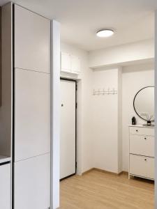 a room with white cabinets and a mirror at AURA apartment Vogošća, Sarajevo in Vogošća +25 photos