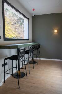 a conference room with chairs and a large window at Alojamientos El Parque in Rute