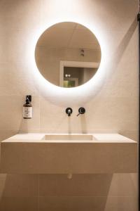 a bathroom with a sink and a mirror at Alojamientos El Parque in Rute +29 photos
