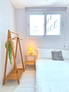 a bedroom with a bed with a ladder next to a window at Stayrium Sagajeong in Seoul