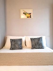 a bed with two pillows on it in a room at Stayrium Sagajeong in Seoul