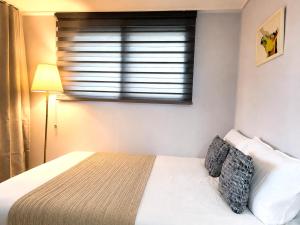 a bedroom with a white bed and a window at Stayrium Sagajeong in Seoul +20 photos