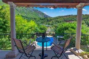 a patio with chairs and a table with a view at VILLA Mara in Dubravka