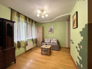 a living room with a couch and a table at Private Apartment in Morshin