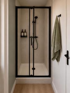a shower with a glass door in a bathroom at Appartement Dunkerque cocooning centre ville in Dunkerque
