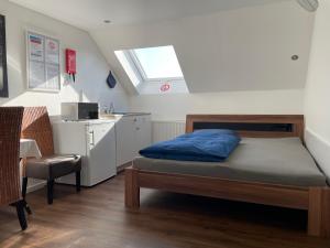 a bedroom with a bed and a sink and a window at Ferienzimmer Saarlouis in Saarlouis +44 photos