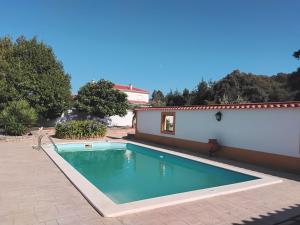 a swimming pool in front of a house at Sol Lua House in Fátima