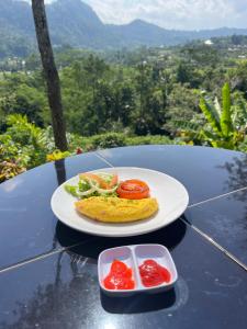 a plate of food with tomatoes on a table at Sidemen padi villas in Silebeng +113 photos