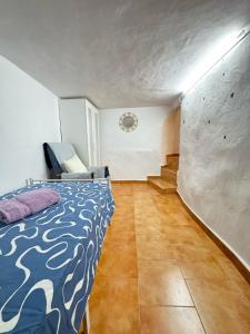 a bedroom with a bed and a staircase in it at Villa Rueda in Moratalla