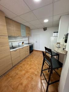 a kitchen with two chairs and a table and a counter at Villa Rueda in Moratalla