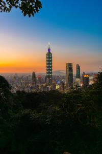 a view of a city skyline at sunset at Guide Hotel Taipei Xinyi in Taipei +94 photos