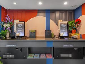 a cashier counter in a store with flowers at Guide Hotel Taipei Xinyi in Taipei