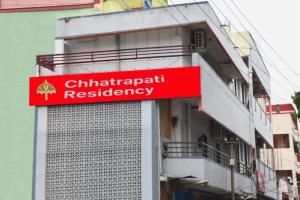 a red sign on the side of a building at Chhatrapati Residency in Tirupati