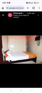 a picture of a bedroom with a bed in a room at Chhatrapati Residency in Tirupati