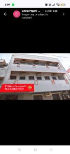 a building with a red sign on the side of it at Chhatrapati Residency in Tirupati