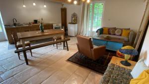 a living room with a table and a couch at Moulin sous la Vergne in Nanteuil-en-Vallée