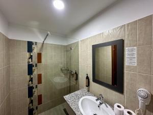 a bathroom with a sink and a mirror at Hotel Nalba-Dalia Jupiter in Jupiter +66 photos