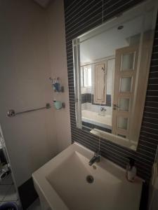 a bathroom with a sink and a mirror at Front de mer Chott Mariem in Chott Meriem +20 photos