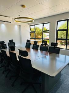a large conference room with a large table and chairs at The Royal Gem Hotel in Jwaneng