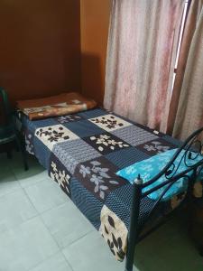 two beds sitting next to each other in a room at Foothill Lodge in Guwahati