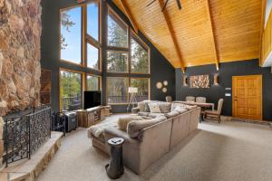 a large living room with a couch and a tv at Spacious Flagstaff A-Frame Casita Getaway in Flagstaff
