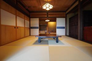 an empty room with a table in the middle of it at Yamanoto in Toyooka +28 photos