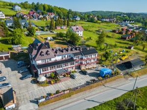 an aerial view of a town with a large building at Przystań Caryńska w Polańczyku in Polańczyk