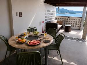 a table with a plate of food on a balcony at 風の音 in Motobu