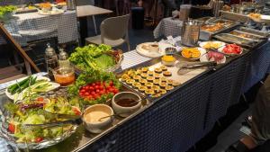 a buffet line with many different types of food at THE STAR HOTEL - PHU MY HUNG, HO CHI MINH - Korean Buffet Breakfast in Ho Chi Minh City