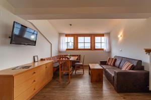 a living room with a couch and a table at Krebishof Agriturismo in Schenna