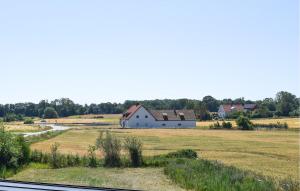 a barn in the middle of a field with houses at 3 Bedroom Nice Apartment In Sölvesborg in Sölvesborg