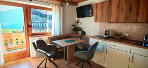 a kitchen with a table and chairs and a window at Obernberg in Aurach bei Kitzbuhel +65 photos
