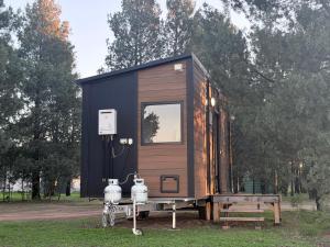 a tiny house on a trailer with a bench at plain Bush in Bohena Creek