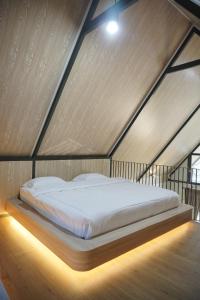 a bedroom with a large bed in a room at Teras Bumi Cabin in Haurkuning
