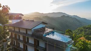 a building with a swimming pool on top of it at Crystal springs mount face Hotel in Ella