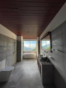 a large bathroom with two sinks and a tub and a tubermott at Crystal springs mount face Hotel in Ella