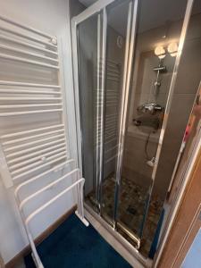 a shower with a glass door in a bathroom at Les Angères in Saint-Martin-d'Uriage